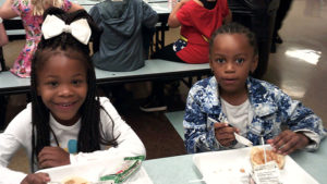 Two Jefferson students pose for a picture while enjoying their pancake breakfast.