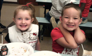 Two Jefferson students smile for the camera after they have finished eating their pancakes.