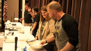 Mr. Chiaro, along with three other teachers prepare pancakes for the student breakfast.