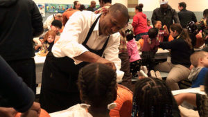 Mayor Franklin helps to clean out a pumpkin.