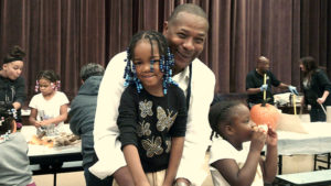 Mayor Franklin poses for a picture with a kindergarten student as he helps to carve the pumpkin.
