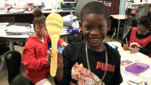 A second grade Jefferson student showing off his completed book craft.
