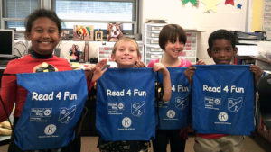 Four Jefferson second grade students show the free drawstring backpacks they received as a gift from United Way.