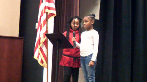 Two second grade students lead one of the songs during the program.