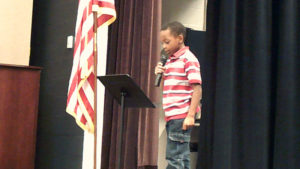 A Jefferson student reads a poem for the Veterans Day program.