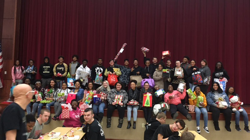 Harding students show off the gifts they purchased for Jefferson students.