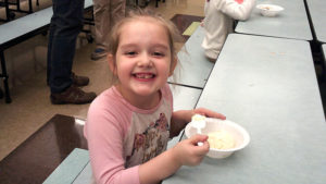 A first grader enjoying her ice cream.