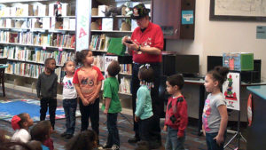 Volunteers watch as the trick is explained.