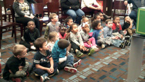 Students watch as a magic trick is performed.