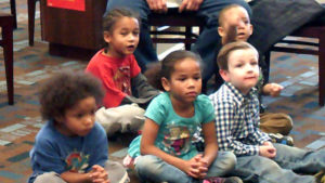 Preschool students watching the magic show.