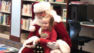 A student sits with Santa.