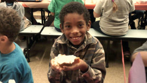 A first grade student ready to enjoy his pumpkin pie.