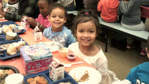 Two kindergarten students enjoying their pumpkin pie.