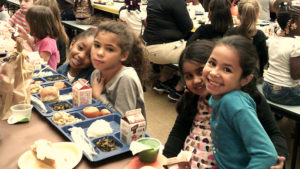 First grade students enjoying their meal.