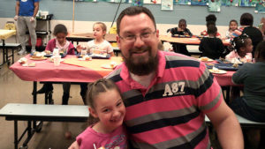 Mr. Bitner and a first grade student enjoying the Thanksgiving lunch.