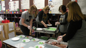 Staff prepared and served students for Green Eggs and Ham day.