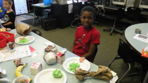 A Kindergarten student enjoys his green eggs and ham.