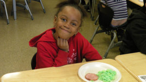 A first grader enjoying her breakfast.