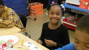 A first grader enjoying her breakfast.