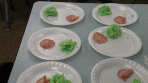 Plates prepared for the students of green eggs and ham.