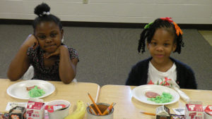 Two Kindergarten students enjoying their special breakfast.
