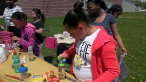 A third grader works to make her calming jar craft.