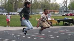 A third grader and a Harding student show off their jump rope skills.