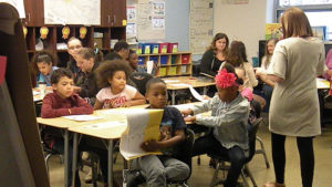 Students wait as the next person gets ready to recite their poem.