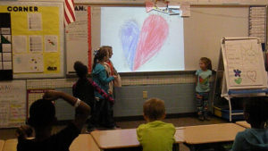 A group of second grade students recite a poem that they worked on together.