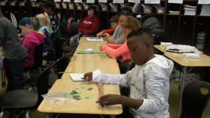 A student uses his math tools to figure out a math problem.