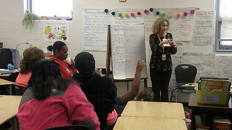 Families watch on as a 4th grade class learns about their activity.