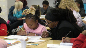 A student and her guest working hard to figure out the math problem.