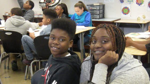 A student and her guests smile for a picture during family day.