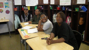 A student and her guests smile for a picture during family day.