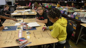 Students working at their desks figuring out their math puzzles.