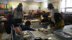 Students and family members work together on a science activity.