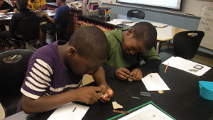 Two students work on an assignment in science class.