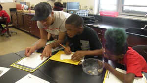 A student and family member work together on an assignment.