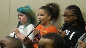 Students performing a piece on their recorders.
