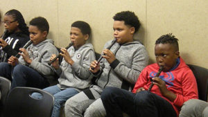 Students perform a warm-up on their instruments before the concert.