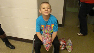 A student helper passes out candy.