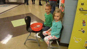 Kindergarten students wait to pass out candy.