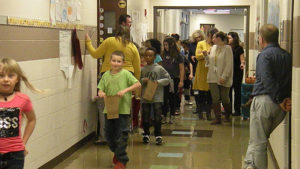 Students and teachers line the halls ready for the candy walk to begin.