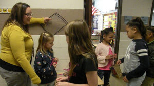 Students walk down the first grade hallway to collect their candy.