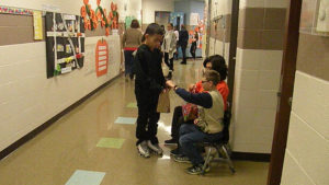 A student gets his candy from one of the classrooms.