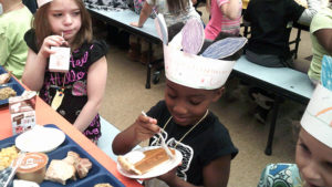 A student enjoys their pumpkin pie for dessert.