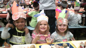 Kindergarten students enjoy their lunch together.