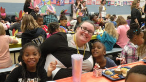 Mrs. G sits with some students for the Thanksgiving lunch.