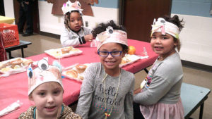 Kindergarten students enjoy their lunch together.