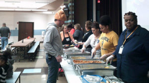 Mr. Guthrie looks on as staff gets ready to serve the students.